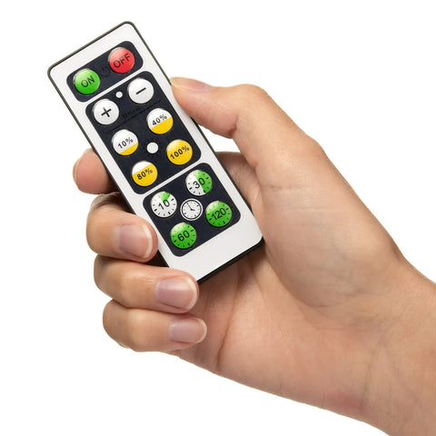 Hand holding remote for Under Cabinet Lighting Kit With 6 Wireless Remote Dimmable LED Puck Lights In Black Easy Install Auto Off Timer 3000K