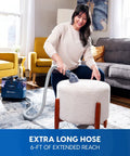 Person using Portable Carpet And Upholstery Spot Cleaner With SixFoot Hose For Deep Stain Busting On Carpets Rugs Furniture And Auto Interiors Lightweight Design For Easy Lifts And Quick Cleanup on an ottoman