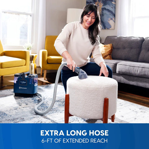 Person using Portable Carpet And Upholstery Spot Cleaner With SixFoot Hose For Deep Stain Busting On Carpets Rugs Furniture And Auto Interiors Lightweight Design For Easy Lifts And Quick Cleanup on an ottoman
