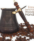XXL Copper Cezve Coffee Pot With Wooden Handle, Hand Engraved And Hammered Solid Copper Ibrik Briki For Stovetop Turkish Greek Arabic Coffee, 28 Fl Oz Old School Antique Vibe Pro Grade with detachable wooden handle on coffee beans.