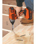 20V Max Cordless Impact Driver Kit With One Quarter Inch Quick Release Chuck Delivers Up To One Thousand Three Hundred Seventy Five Inch Pounds Torque, Three Thousand RPM, And Three Thousand Nine Hundred IPM, Plus A Soft Touch Grip For Beast Mode in use on wooden surface