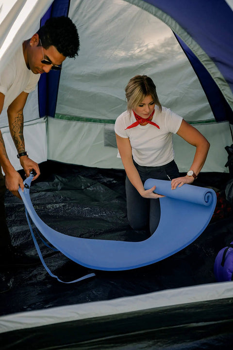 Two campers setting up Pack Lite Camping and Backpacking Sleeping Pad Lightweight Closed Cell Foam Mat in a tent