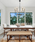 8 Light Farmhouse Chandelier With Dope Black And Gold Finish Modern Candle Pendant Lighting over dining table in bright room