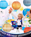 Child celebrates under Eight Pack 12 Inch Space Paper Lanterns With Hanging Planets, Two Sizes, Out Of This World Solar System Theme Party Decorations For Classroom Or Birthday, Outer Space Hanging Decor.