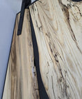 Close-up of Handcrafted Live Edge Spalted Hackberry Barn Door With Custom Sizing Made To Order In Minnesota Totally One Of A Kind Rustic Modern Wood Door For Hallway Or Entryway showing wood grain and metal hardware.