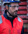 Worker wearing Silex Safety Glasses With Anti Scratch Anti Fog Coating Black Blue Frame Clear Lenses at construction site.