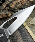 Close-up view of Folding Pocket Knife With D2 Steel Blade And Lightweight T6 Aluminum Alloy Handle on wooden surface.