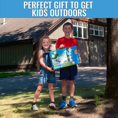 Two children holding box of Kid Ninja Warrior Obstacle Course Set With 2 x 60 Foot Slacklines outdoors.