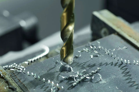 Close-up of 21 Piece Cobalt M42 Drill Bit Set With Case And Three Flat Shank For Stainless Steel drilling into metal surface