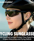 A woman wearing cycling sunglasses with ANSI-certified lenses for eye protection, outdoor cycling gear visible.