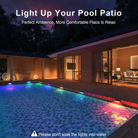Ambient poolside view with Solar Fence Lights Outdoor Waterproof 4 Pack With Warm White And RGB Color Changing Modes lit up.