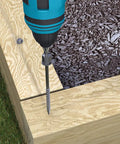 Close-up of a drill inserting TimberTite Landscape Screw into a wooden deck, showing the hex washer head and ceramic coating.