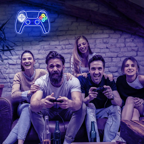 Gamepad Shaped LED Neon Sign for Gaming Room Decor glowing on wall above people gaming.