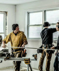 Workers using Gel Cushions Bluetooth Hearing Muffs With Active Mic 26 dB NRR on a construction site with power tools.