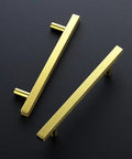 Gold Cabinet Pulls 30 Pack 5 Inch Modern Square Brushed Brass Drawer Handles For Kitchen Cabinets With Durable Brushed Brass Finish And Easy Install Upgrade Your Kitchen 7 3 8 Inch Overall Length. Two pulls on black surface, top view.