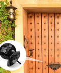 Solid 12 Pack Iron Clavos 1.5 Inches Long Featuring Gritty Hammered Black Finish on rustic wooden barn door.