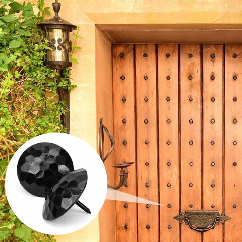 Solid 12 Pack Iron Clavos 1.5 Inches Long Featuring Gritty Hammered Black Finish on rustic wooden barn door.