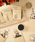 Brown Seed Packets 4.5 By 3.25 Inches 100 Pack Blank Envelopes with seeds and handwritten labels on a wooden table.