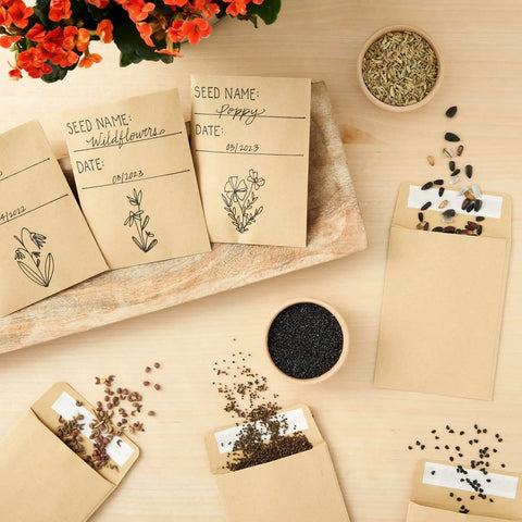 Brown Seed Packets 4.5 By 3.25 Inches 100 Pack Blank Envelopes with seeds and handwritten labels on a wooden table.