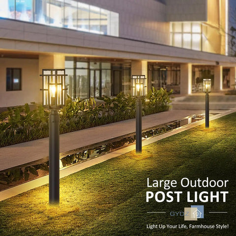 Outdoor Dusk To Dawn Post Light Set In Matte Black With Clear Glass Panels along garden pathway at night
