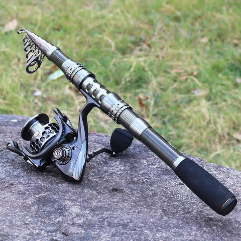 Travel Ready Telescopic Fishing Rod Combo With Spinning Reel And Carrier Bag Includes Lures And Line For Saltwater And Freshwater Angling Kit Grab And Go 1.8M Telescopic Pole For Easy Travel on rock background
