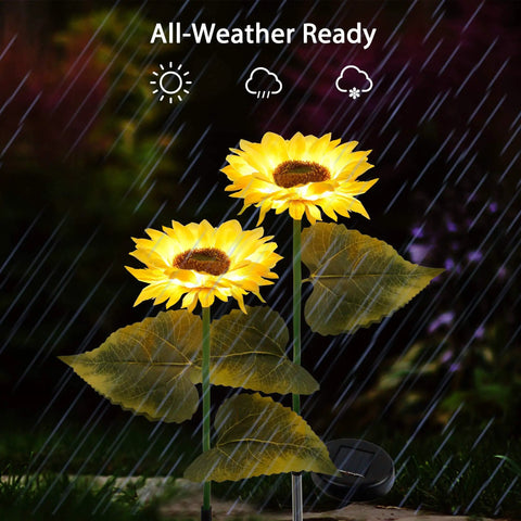 2 Pack Solar Garden Stake Lights Sunflower LED Pathway Lights, glowing in the rain with realistic fabric petals and adjustable stems.