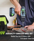 Person using the 20V Cordless Power Drill Driver Kit With Three Eighths Inch Keyless Chuck and green storage bag visible on table.