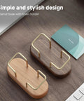 Top view of walnut wood business card holder for desk and office, wooden card display stand with brass accents on a tabletop