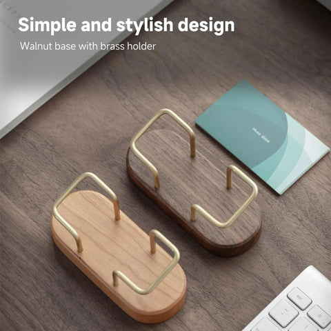 Top view of walnut wood business card holder for desk and office, wooden card display stand with brass accents on a tabletop