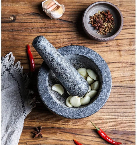 Granite Mortar And Pestle Set For Grinding Spices And Herbs Like A Boss, natural stone with garlic cloves on wooden surface