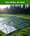 Heavy Duty 9 Inch Galvanized Steel Tent Stakes 25 Pack securing tarp on wet grass in rain