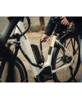 Plug In Chain Lock For Bicycles And Scooters 130 Cm Long Five Point Five Mm Hardened Steel Links in use with white bike