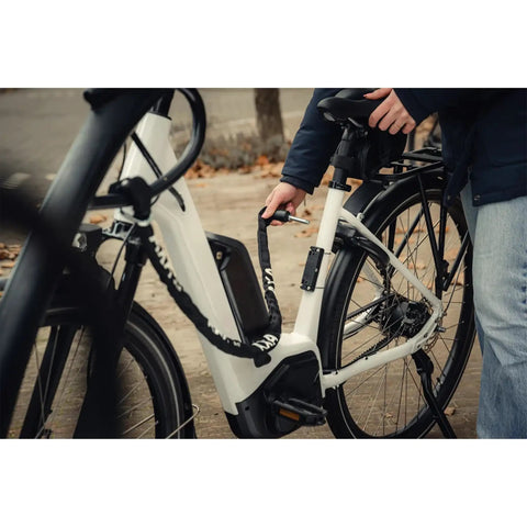 Plug In Chain Lock For Bicycles And Scooters 130 Cm Long Five Point Five Mm Hardened Steel Links in use with white bike