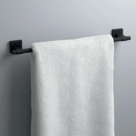 18 Inch Matte Black Towel Bar For Bathroom And Kitchen Corrosion Resistant Towel Rack That Promotes Airflow For Faster Towels Drying And A Dope Modern Home Look holding a white towel