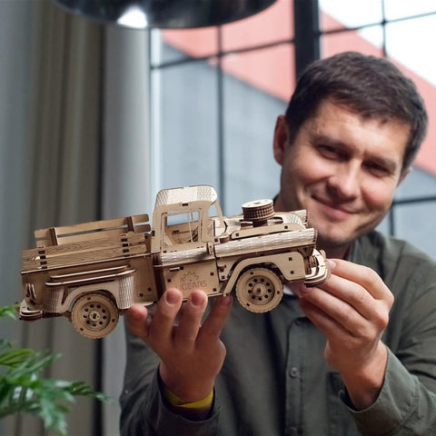 Pickup Lumberjack Mechanical Wood Model Kit For Adults 3D Puzzle And DIY Craft Set With A Spring Motor That Powers A Realistic Working Pickup Truck You Can Build Customize And Display held by man