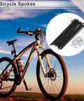 Universal Bicycle Spokes 12G 130mm Length With 1 Set Of 36 Spokes And 36 Nipples Black Carbon Steel next to a bike at sunset