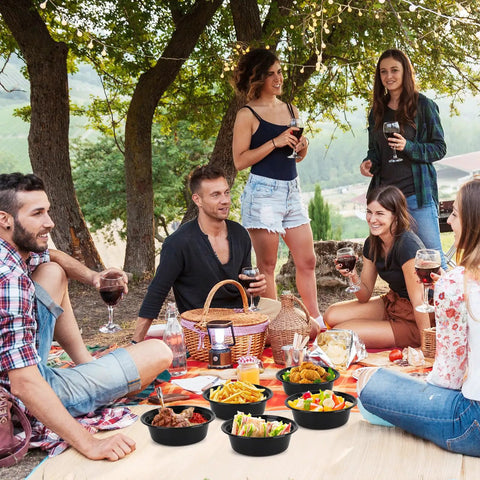 Group enjoying outdoor picnic with Meal Prep Containers With Lids 50 Pack 32 Ounce Round To Go Food Storage Bowls on blanket.