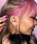 Woman wearing Customizable Gemstone Earplugs With 21 dB Noise Reduction For Clear Hearing at concerts, stylish look