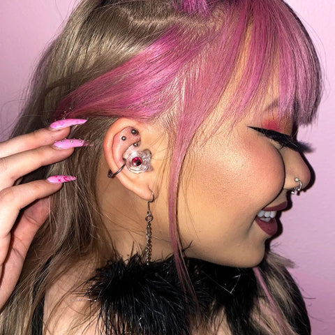 Woman wearing Customizable Gemstone Earplugs With 21 dB Noise Reduction For Clear Hearing at concerts, stylish look