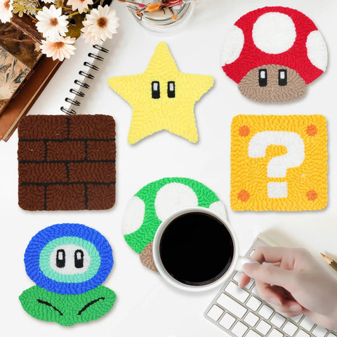 Punch Needle Coaster Kit For Easy DIY Embroidery 6 Piece All In One Set With Fun Patterns Tools Yarns Hoop Instructions And Coaster Holder For Beginners Kids And Adults showing six colorful video game-themed coasters on a table.