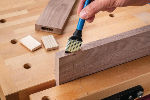 Silicone Glue Brush Set For Beadlock Tenons Ribbed Tenon Shaped Applicators applying glue to wood joint on workbench