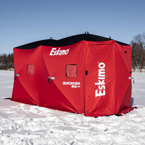 Quickfish Six Person Portable Pop Up Ice Fishing Shelter With Fully Quilted Insulation No Trip Door And Deluxe Anchors For Hell Of A Winter Setup In Red Black viewed on snowy lake.