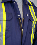 Flame Resistant Hi Vis Coverall For The Jobsite Navy Blue 88 Cotton 12 Nylon Twill 7 Oz Arc Flash Safe 12 Cal Per Cm2 ATPV NFPA 2112 HRC 2 Size Small Pro showing front zipper and reflective stripes.