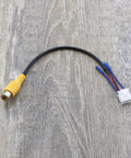 Close-up of a Four Pack 10Pin Car Reversing Camera Cable Adapter For Large Screen Rear View Wiring Harness on wooden surface.