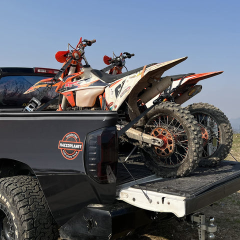 Two motorcycles secured on a truck bed with Heavy Duty Ratchet Straps With Padded Handle 5280 Lb Break Strength One Point Six Inch Wide Tie Down Straps