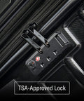 Hard-shell luggage close-up with TSA-approved lock on black surface