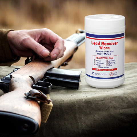 Lead Remover Wipes For Shooting 2 Pack 120 Wipes next to a rifle on a cloth surface
