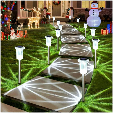 Solar LED Outdoor Stake Lights Pack Of 10 Waterproof Stainless Steel illuminating a garden path at night, holiday decorations visible.