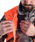 Killer Blaze Orange Ballistic Vest For Men High Visibility Hunting Gear With Water Repellent Finish shown with hands adjusting pocket.