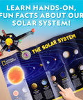 Child pointing at National Geographic poster with solar system chart beside Glow In The Dark Solar System Model Kit For Kids Ages 8-12 Build A 3D Planetary System With Movable Arms Paintable Planets Cool STEM Craft For Space Themed Bedrooms And Decor.